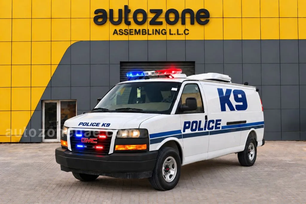 GMC Savana police K9 handler support vehicle with blue stripe livery and roof light bar