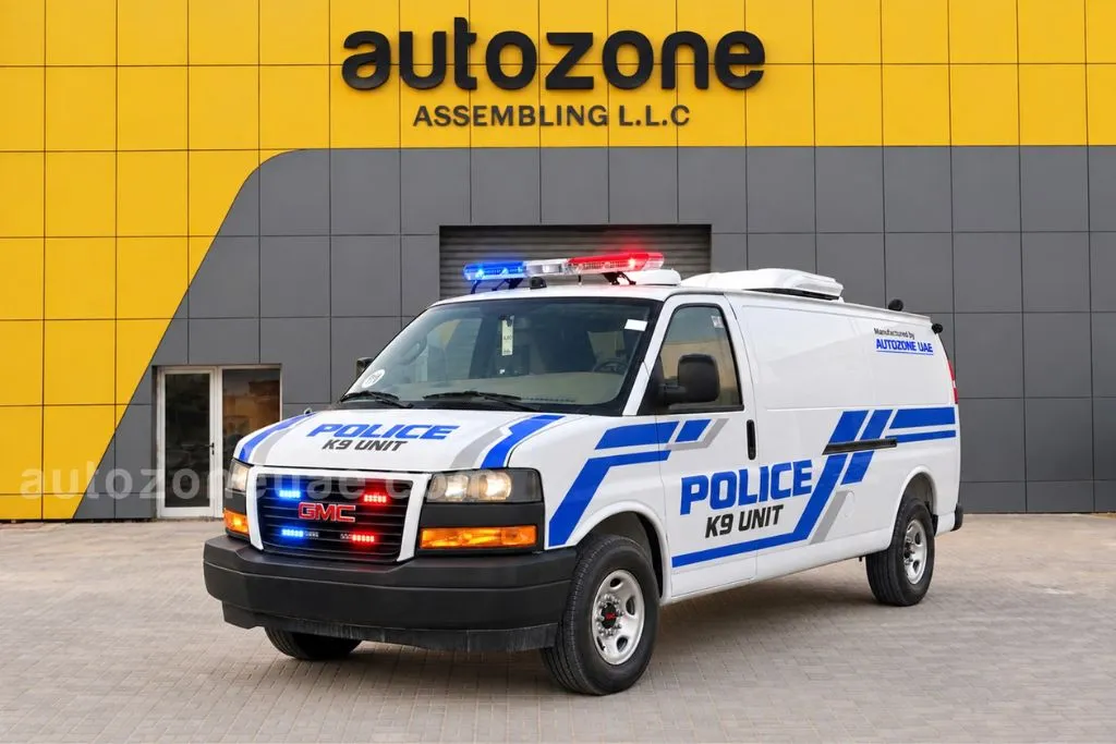 Police K9 unit vehicle built on a GMC Savana van with blue livery and roof light bar